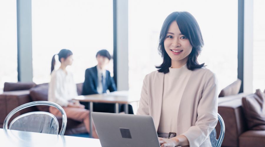 PCの前で笑顔の女性